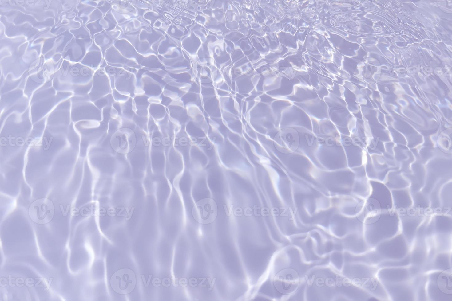 Defocus blurred transparent purple colored clear calm water surface texture with splash, bubble. Shining purple water ripple background. Surface of water in swimming pool. Tropical purple water color. photo