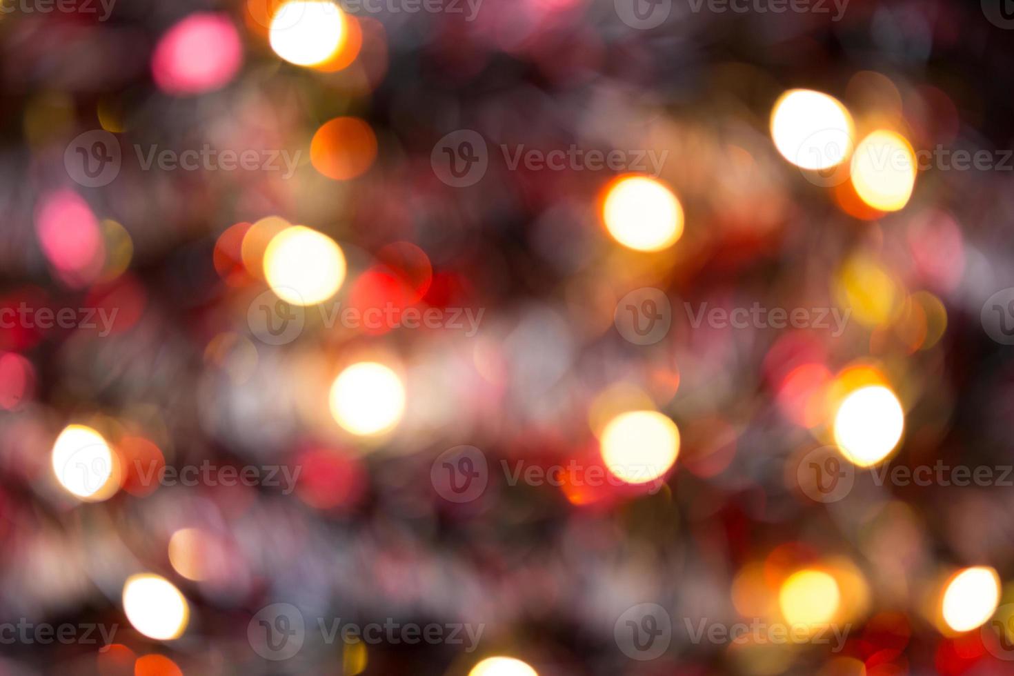 Christmas background with blur Golden lights of garlands in the bokeh. Red tinsel, Christmas tree. New Year. Copy space. photo