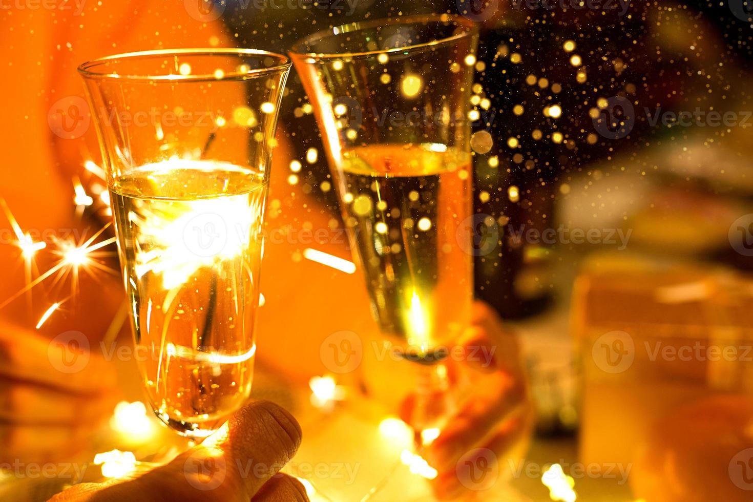 Sparklers in a glass of champagne - transparent glass with wine and splashes. New Year, festive mood, celebration. Christmas photo