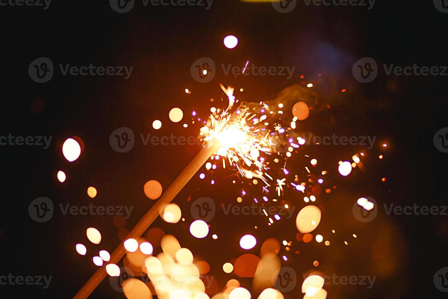 Sparks and sparklers in the dark. Festive fire texture, background for new year and Christmas. photo