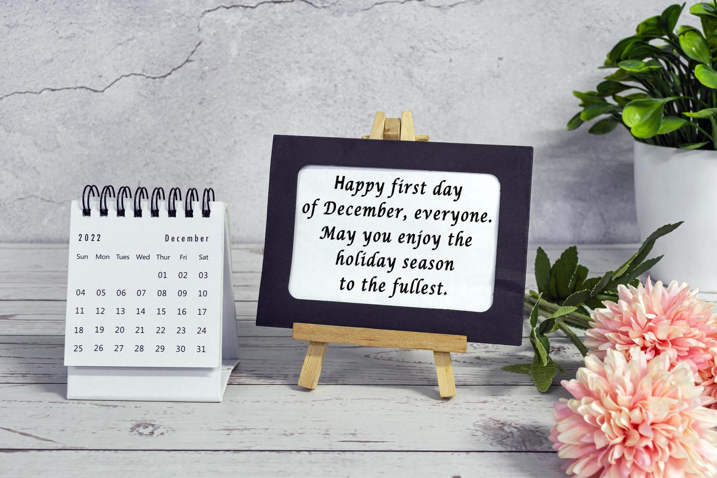 Motivational quotes on paper frame with December 2022 calendar - Happy first day of december everyone, may you enjoy the holiday season to the fullest. photo