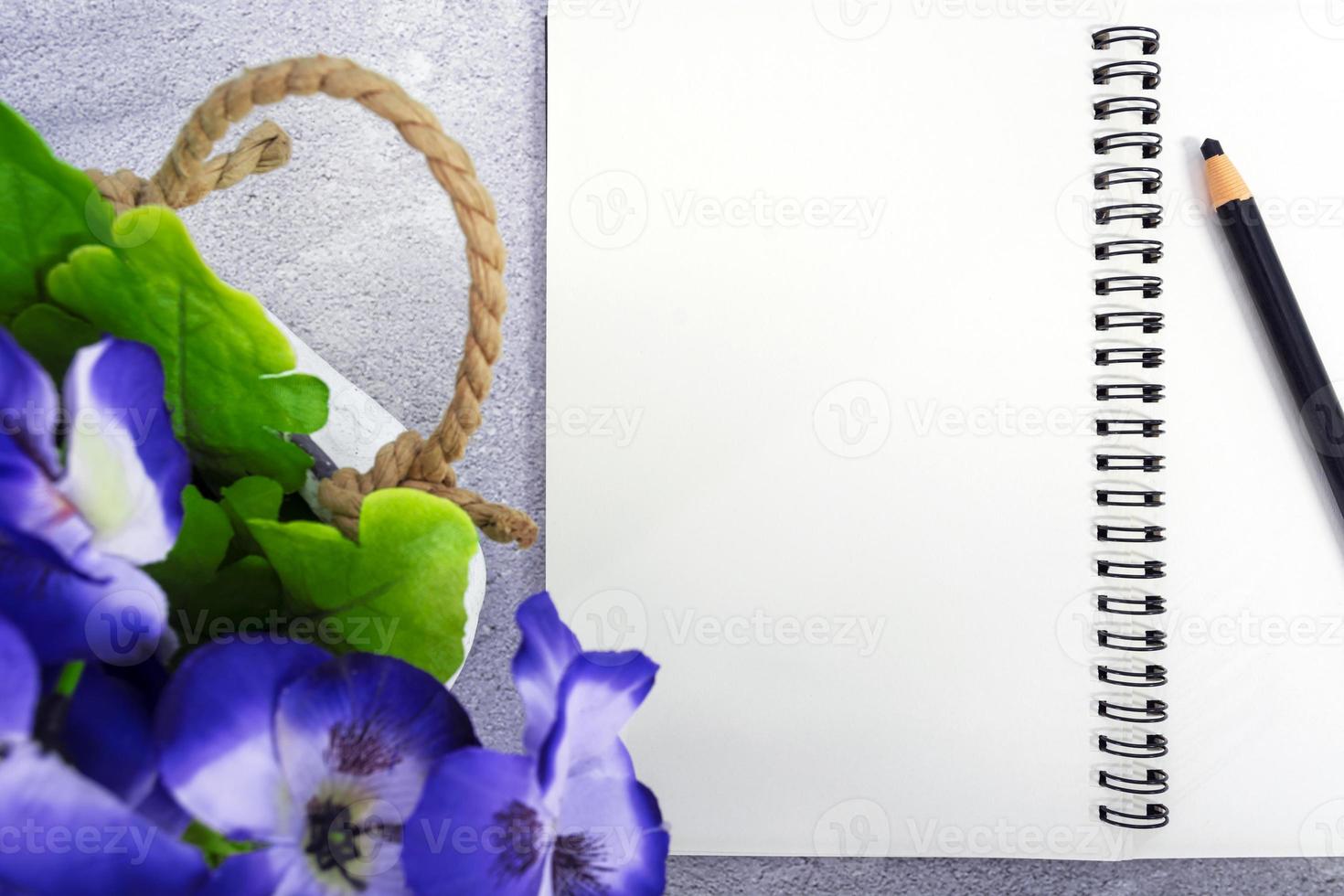 Note book with pen and potted plant on marble table. Directly above. Copy space. photo