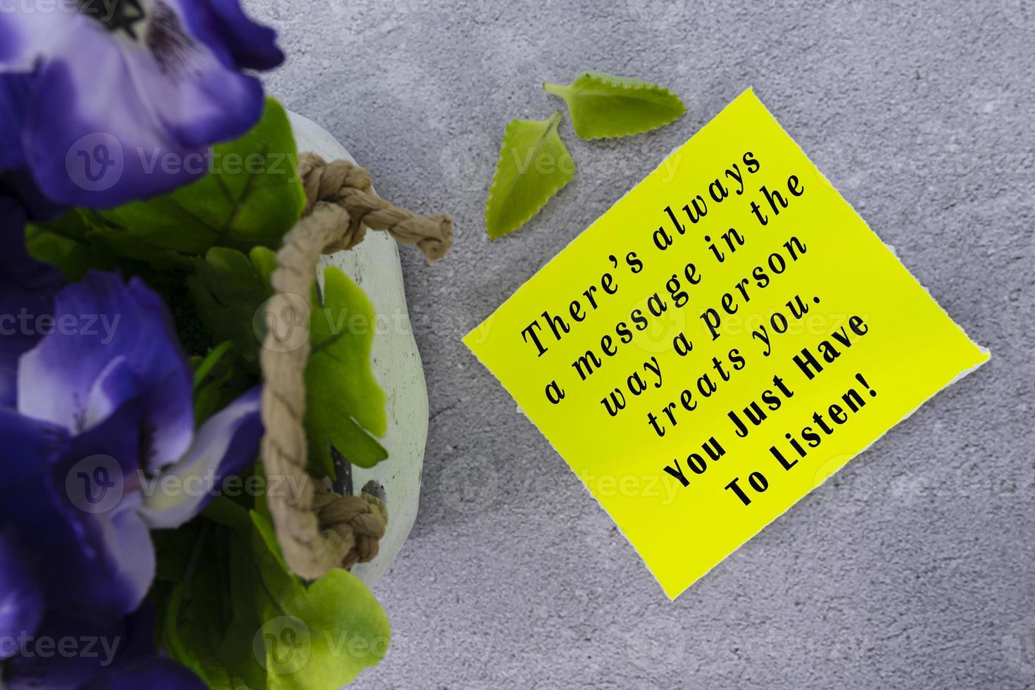 Motivational and inspirational quote on yellow note with flowers. photo