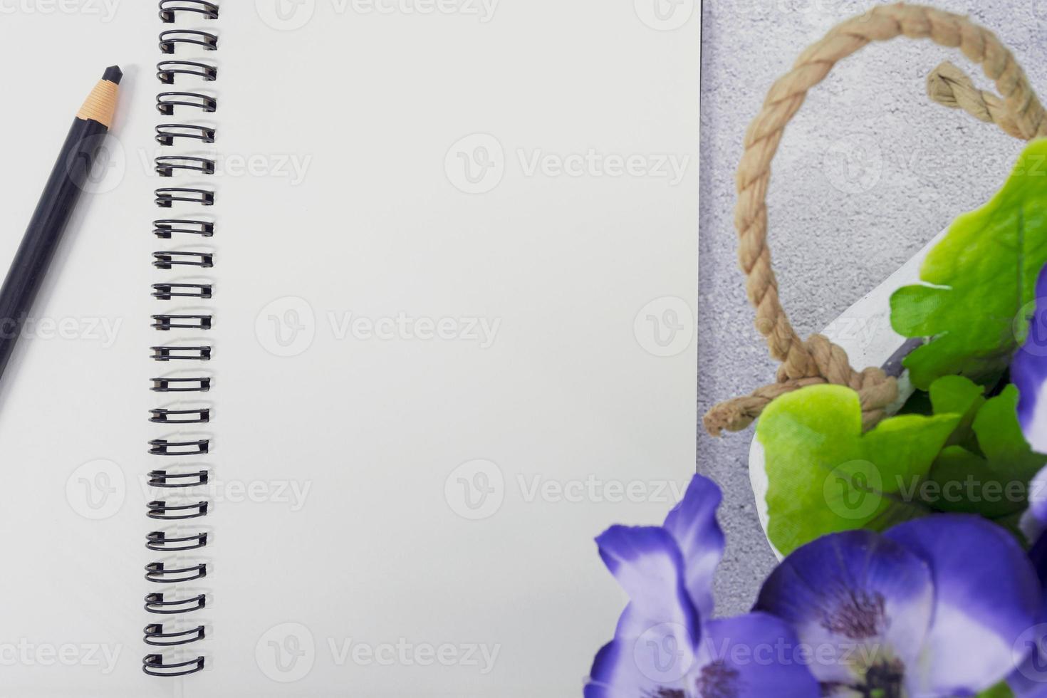 Note book with pen and potted plant on marble table. Directly above. Copy space. photo