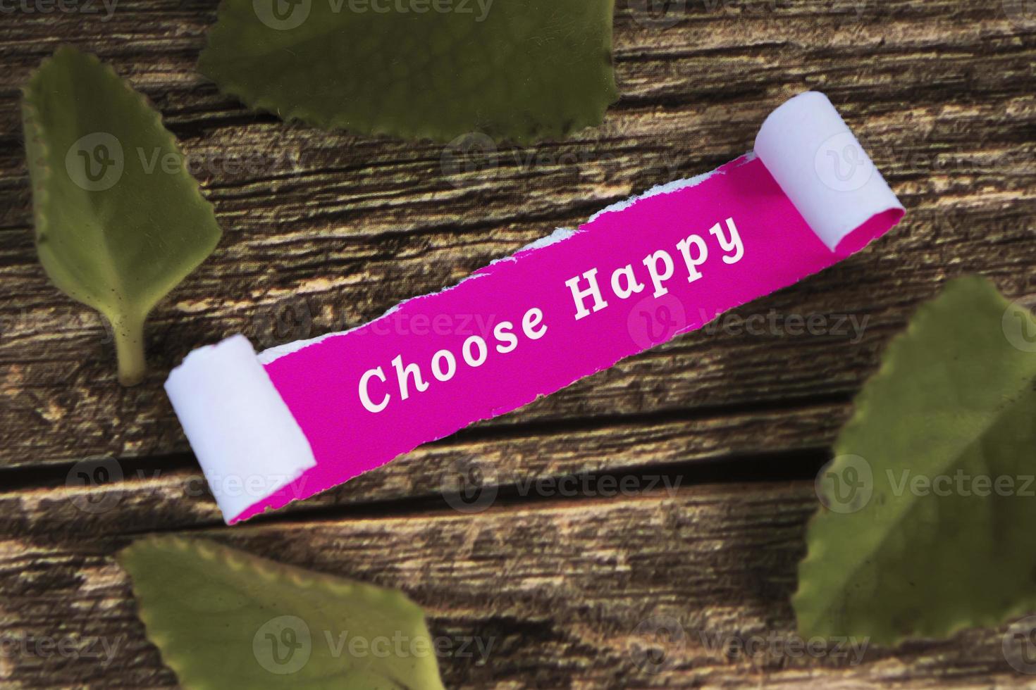 Motivational quote on pink note with leave on wooden desk. photo
