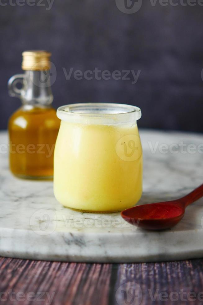 homemade ghee in container on a table , photo