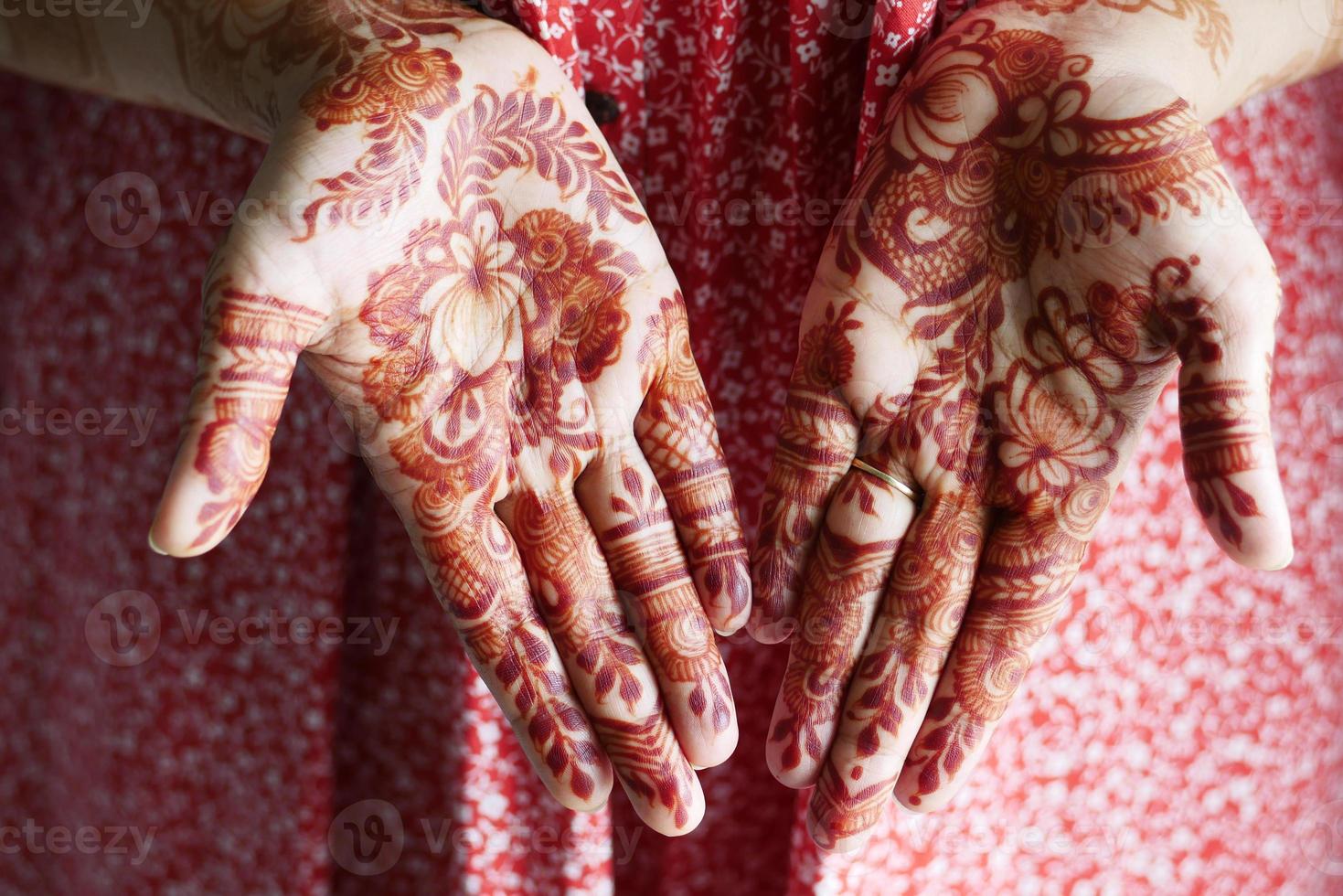 women applying henna on hand photo