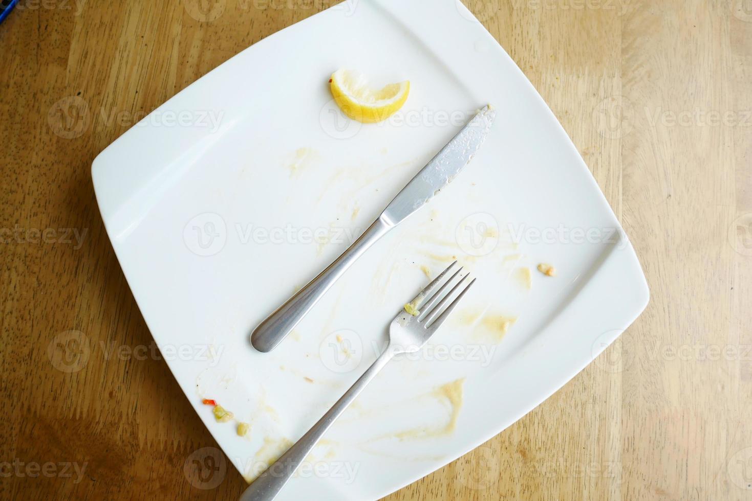 Empty plate after eating on table photo