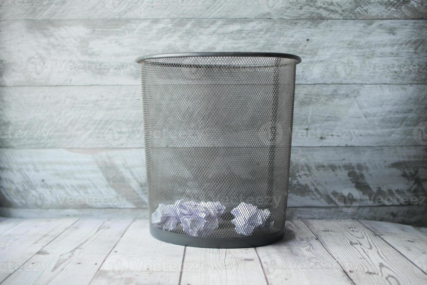 crumpled paper ball in a bin top view photo