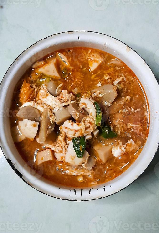 Taste the delicacy of Seblak, namely savory and spicy dishes from Indonesia. Seblak contains vegetables, squid, meatballs, sausage, crackers, eggs, and spices. Seblak is also easy to cook at home. photo