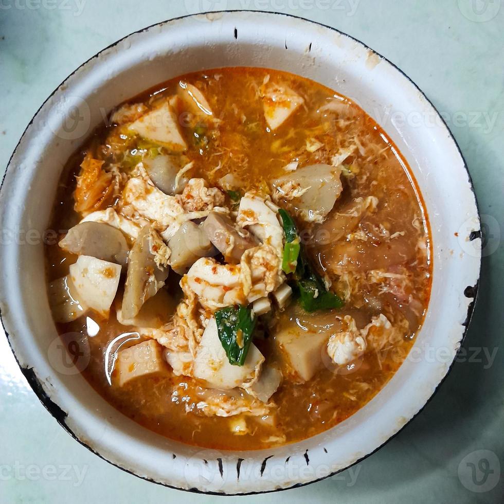 Taste the delicacy of Seblak, namely savory and spicy dishes from Indonesia. Seblak contains vegetables, squid, meatballs, sausage, crackers, eggs, and spices. Seblak is also easy to cook at home. photo