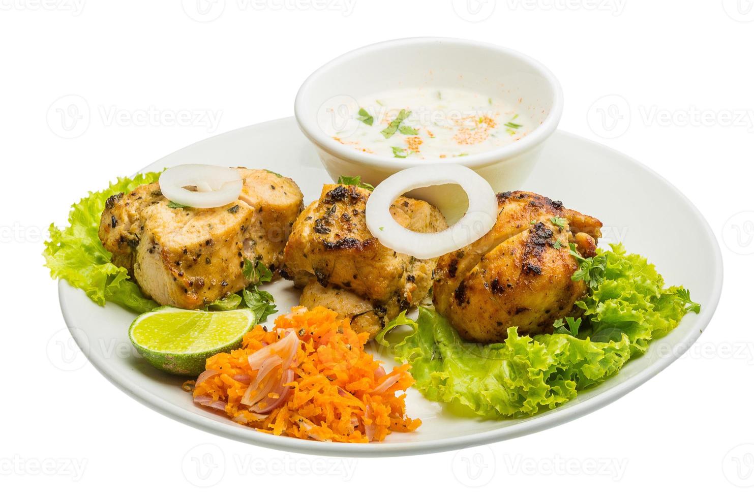 Chicken Tikka on the plate and white background photo