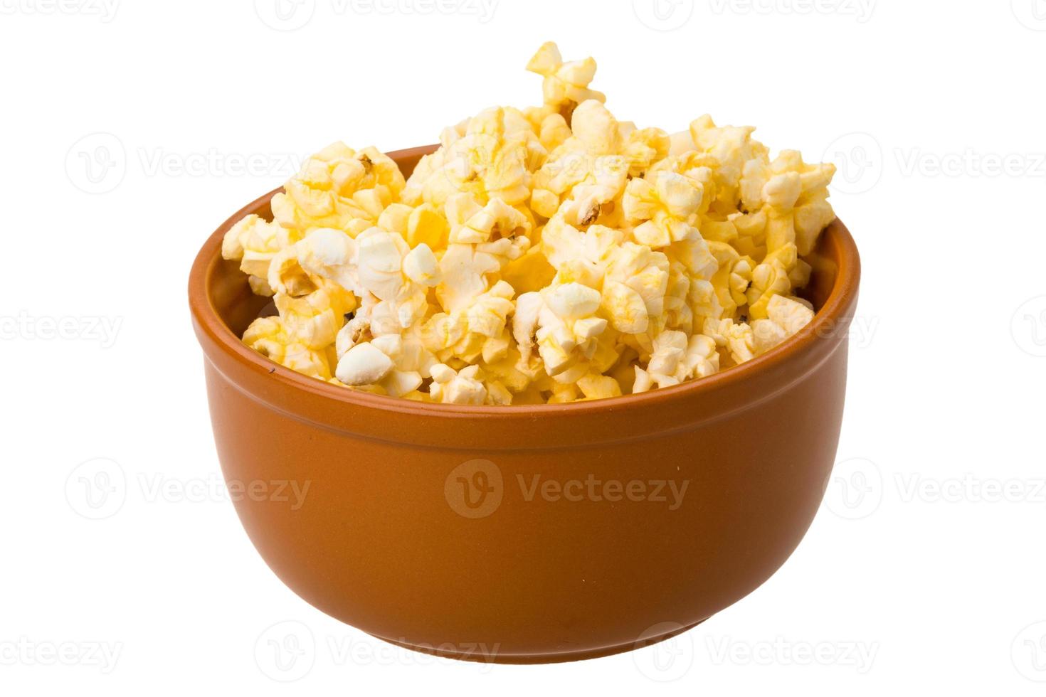 Popcorn in a bowl on white background photo