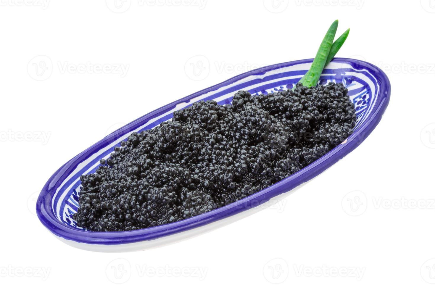 Black caviar in a bowl on white background photo