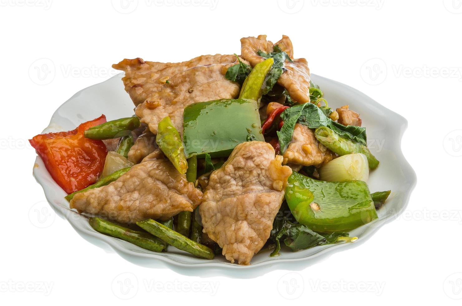 Pork with vegetables on the plate and white background photo