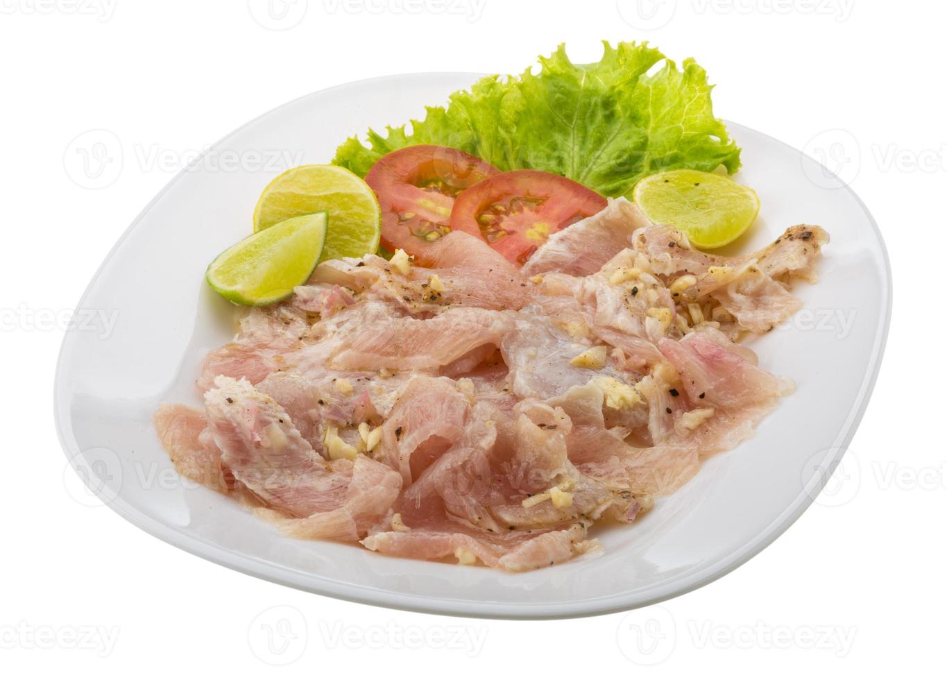 Swordfish carpaccio on the plate and white background photo