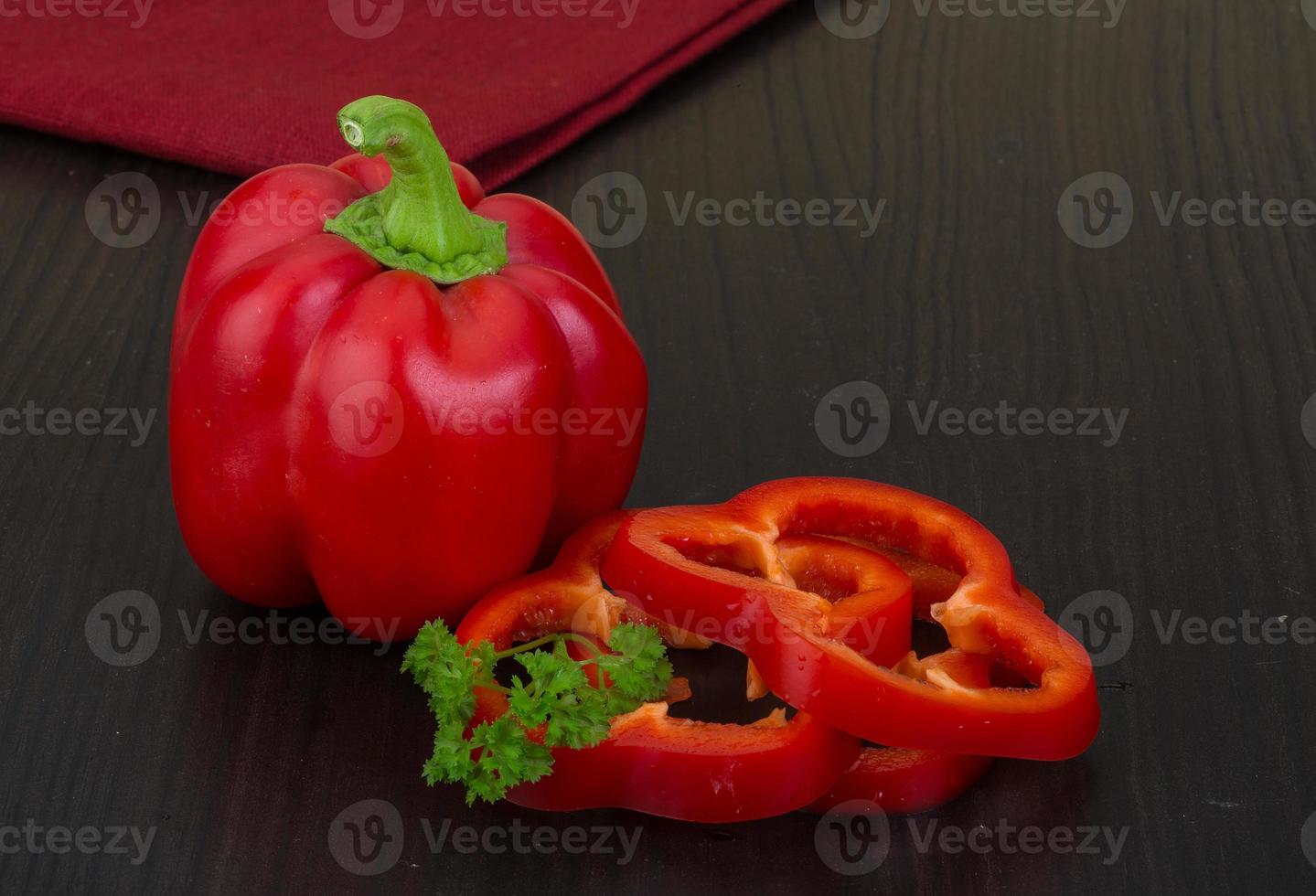 Red pepper on wooden background photo