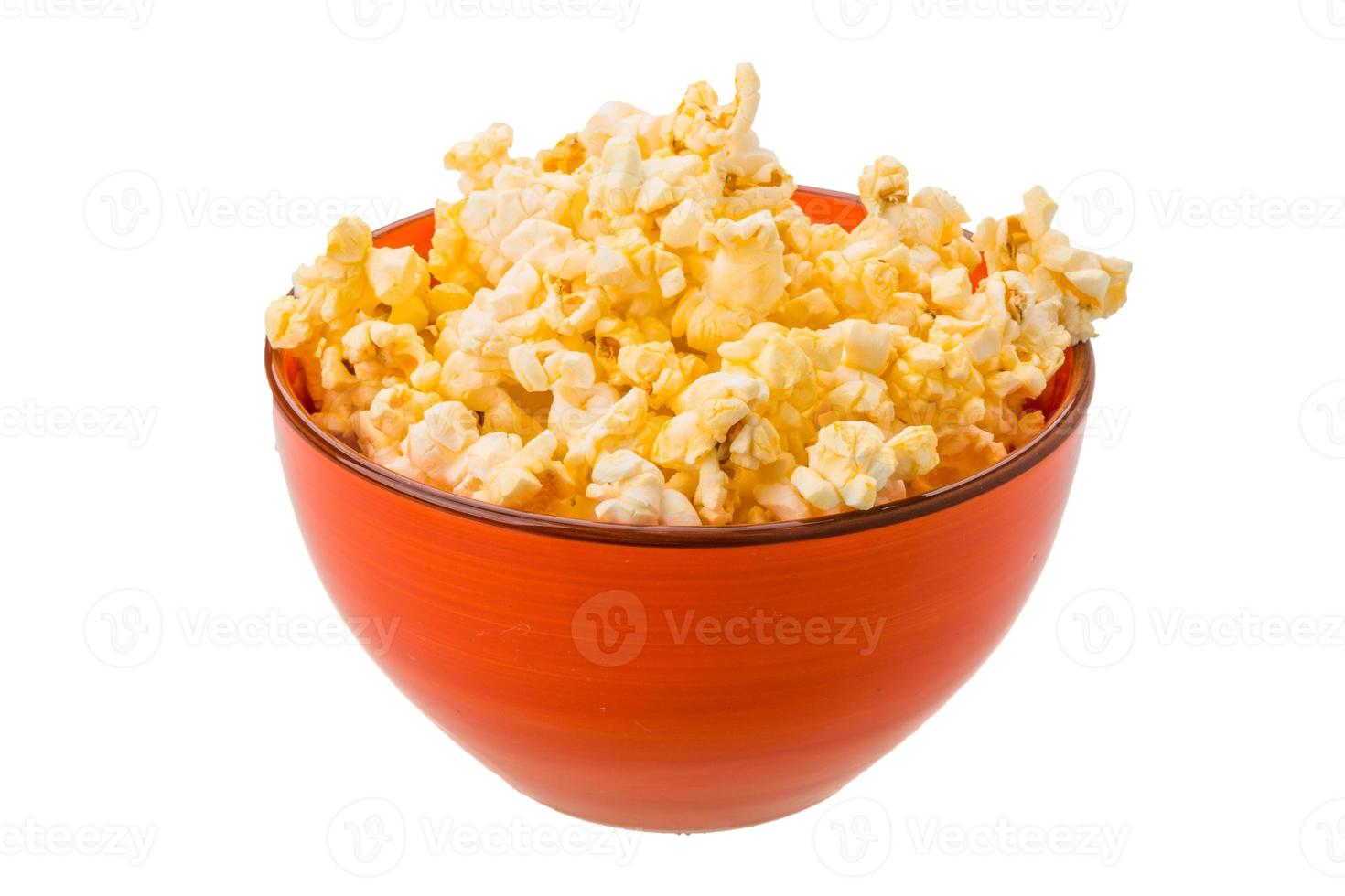 Popcorn in a bowl on white background photo