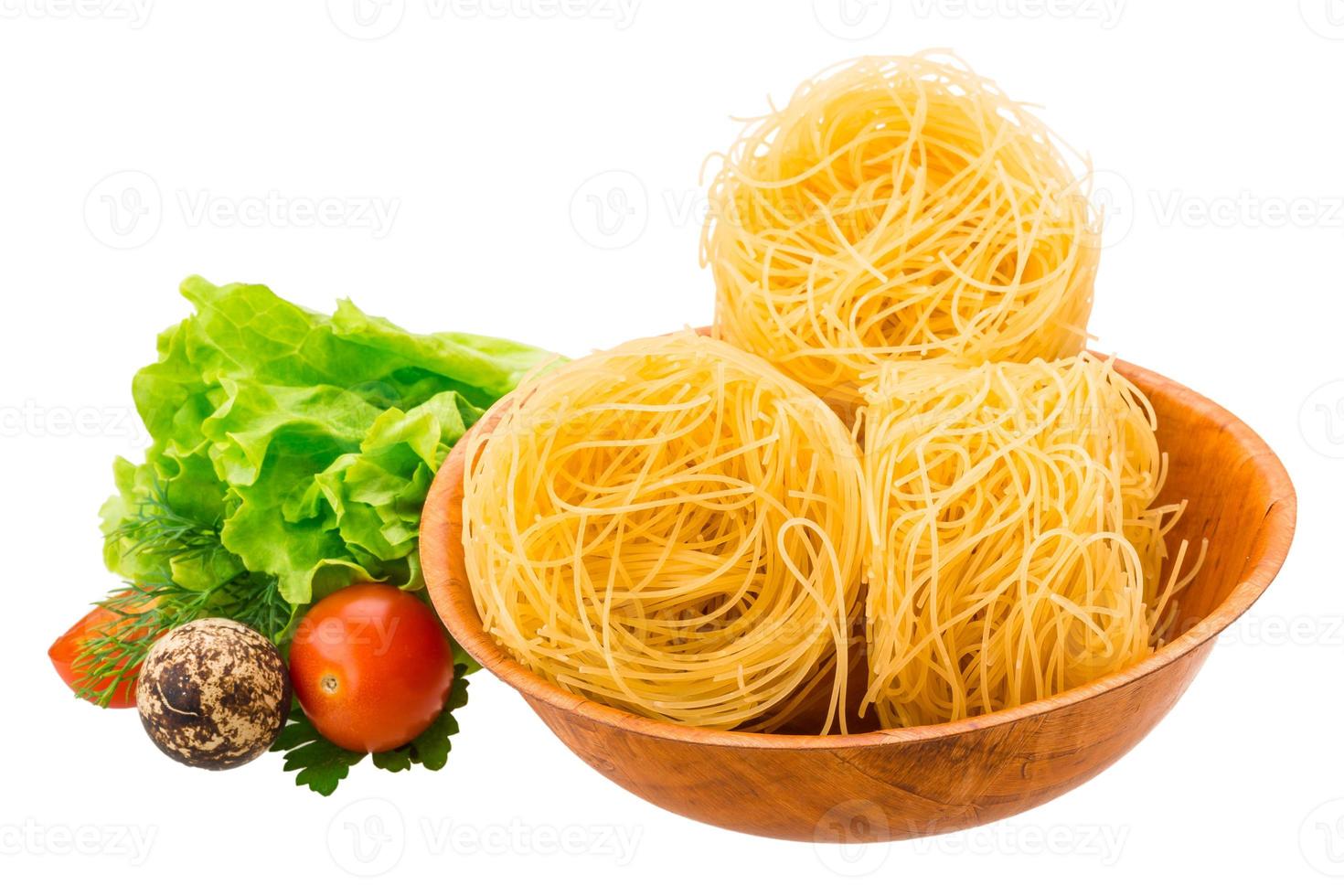 Tagliatelle in a bowl on white background photo