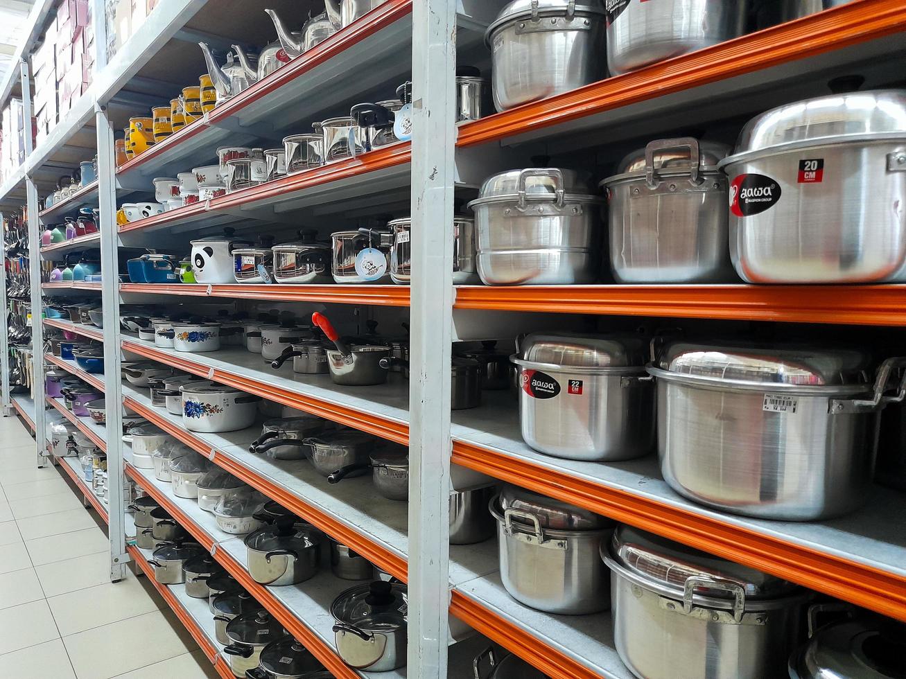Jombang, East Java, Indonesia, 2022 - Rows of pan racks and various other kitchen utensils in supermarkets in Indonesia. portrait of display of household supplies in a shopping mall. photo
