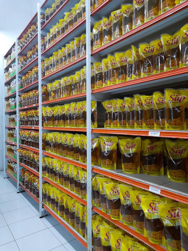 Jombang, East Java, Indonesia, 2022 - The shelves in supermarkets contain rows of halal packaged cooking oil from various brands in Indonesia. portrait of cooking oil display in shopping mall photo