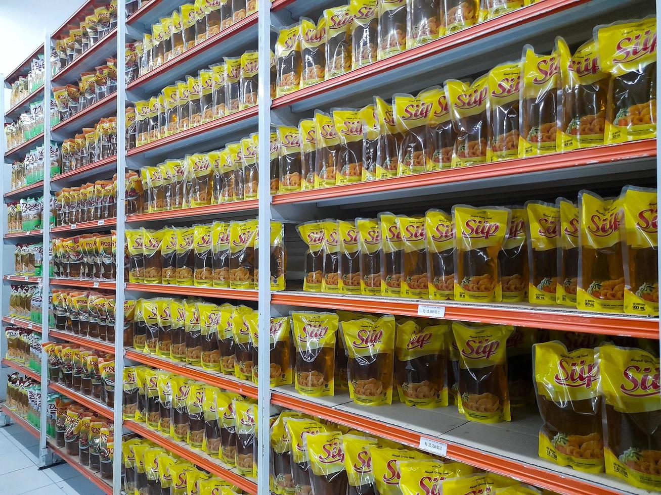 Jombang, East Java, Indonesia, 2022 - The shelves in supermarkets contain rows of halal packaged cooking oil from various brands in Indonesia. portrait of cooking oil display in shopping mall photo