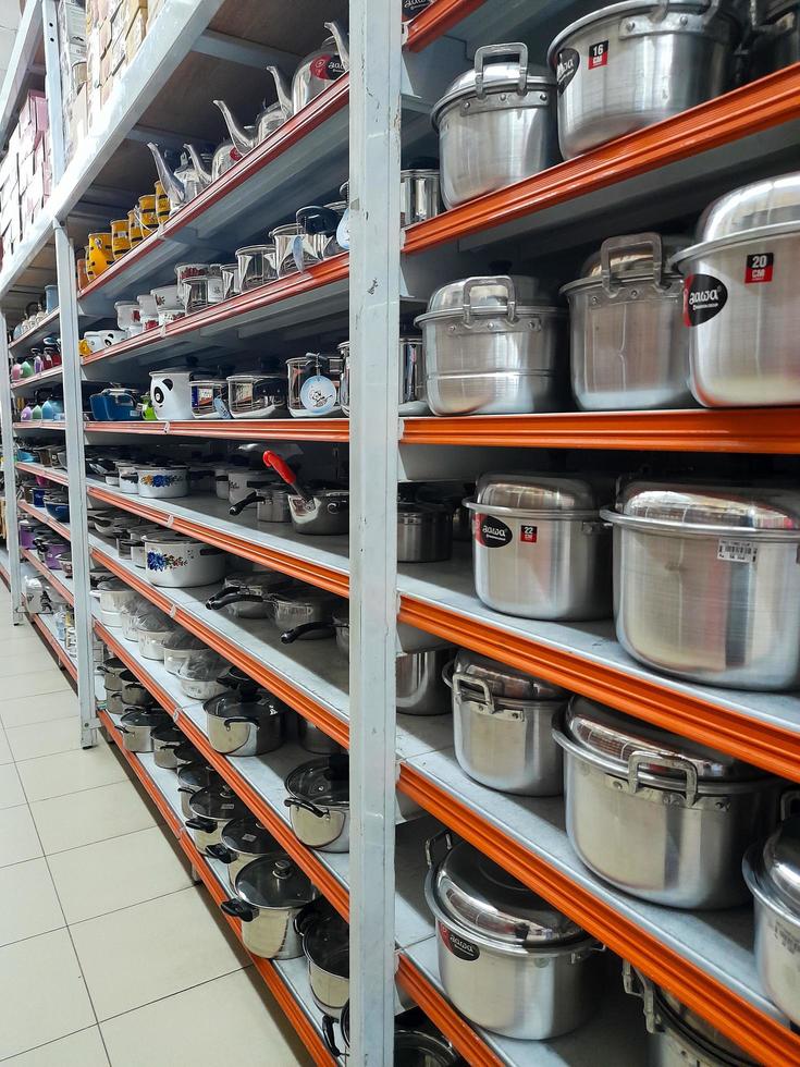 Jombang, East Java, Indonesia, 2022 - Rows of pan racks and various other kitchen utensils in supermarkets in Indonesia. portrait of display of household supplies in a shopping mall. photo