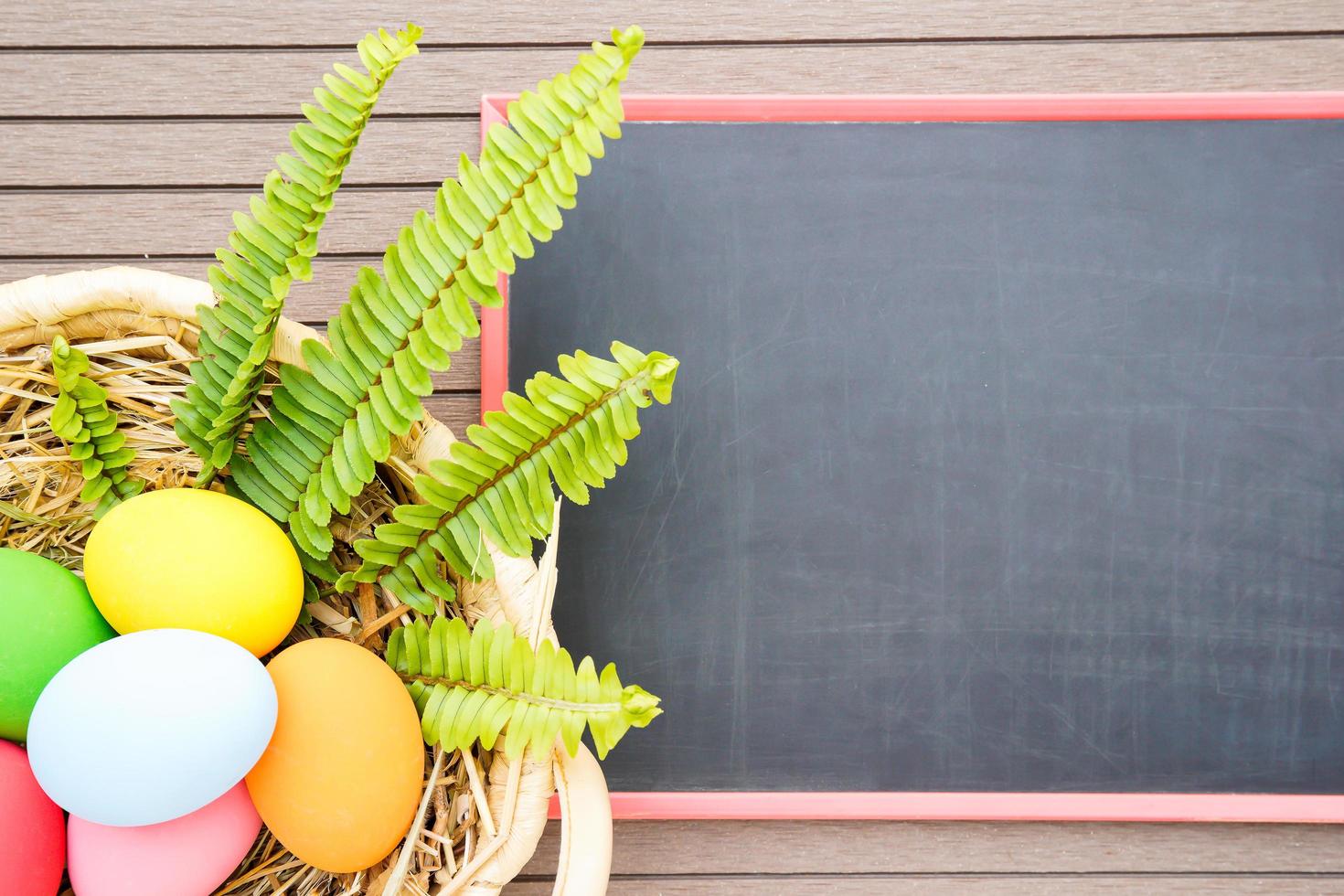 Easter eggs in basket and blackboard photo