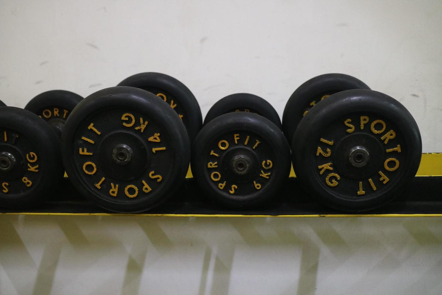 Semarang, Indonesia december 02, 2021 Editorial image of black dumbbells on a rack for working out in a gym photo