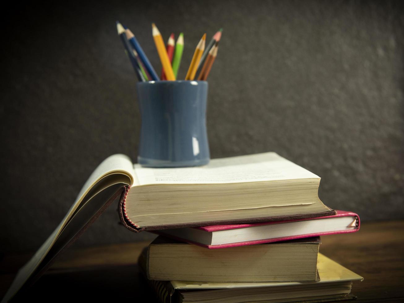 Still life book in library with pencils colour in a pencil case on dark background education concept back to school photo