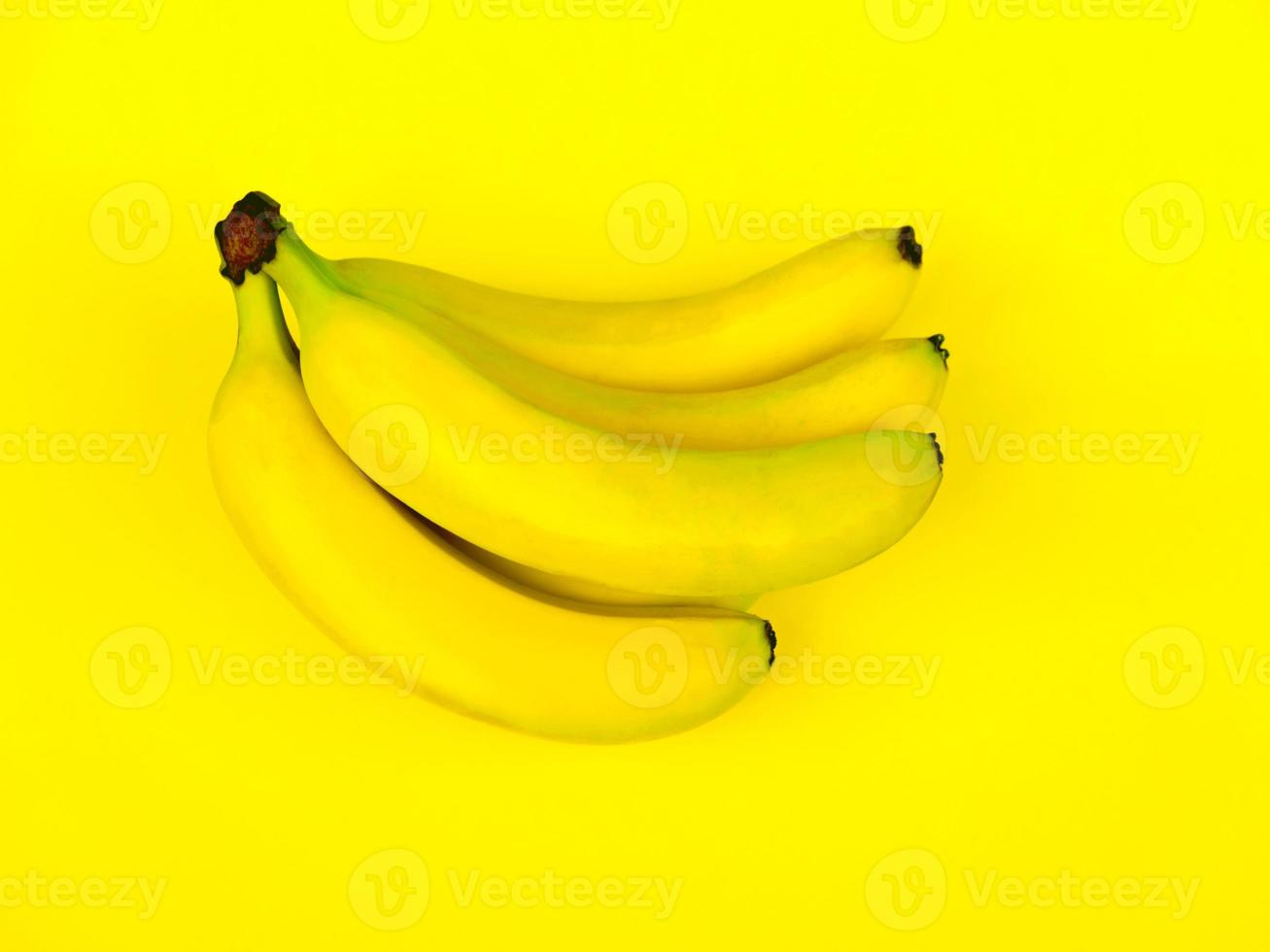 Bunch of bananas on a yellow background, monochrome picture photo