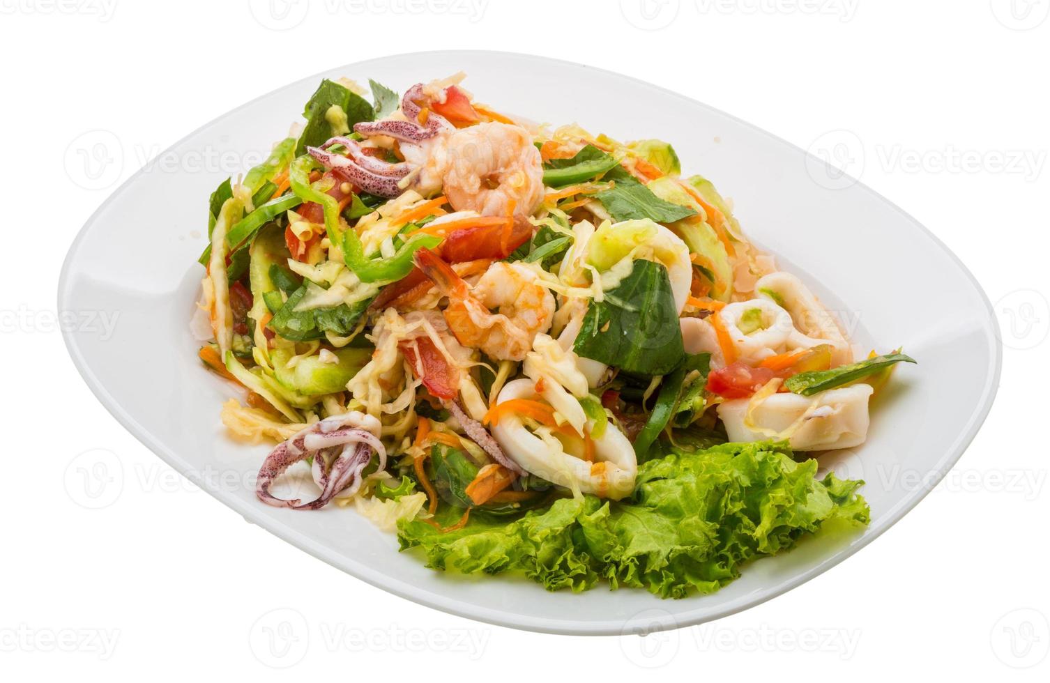 Asian seafood salad on the plate and white background photo