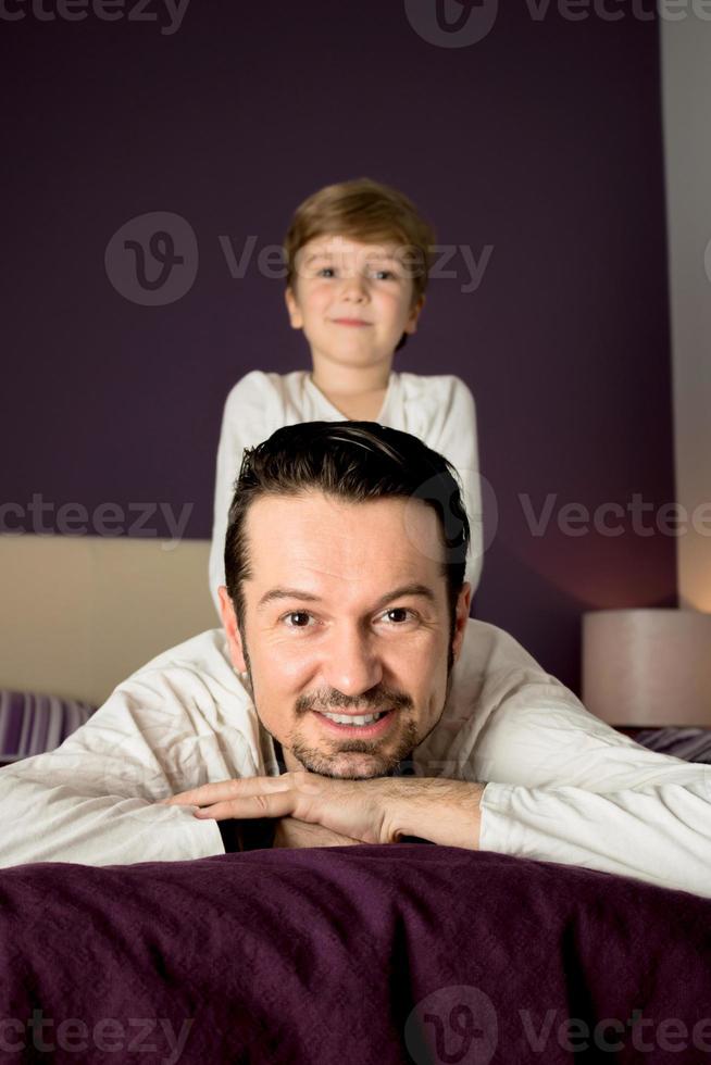 Portrait of father with son in bedroom. photo