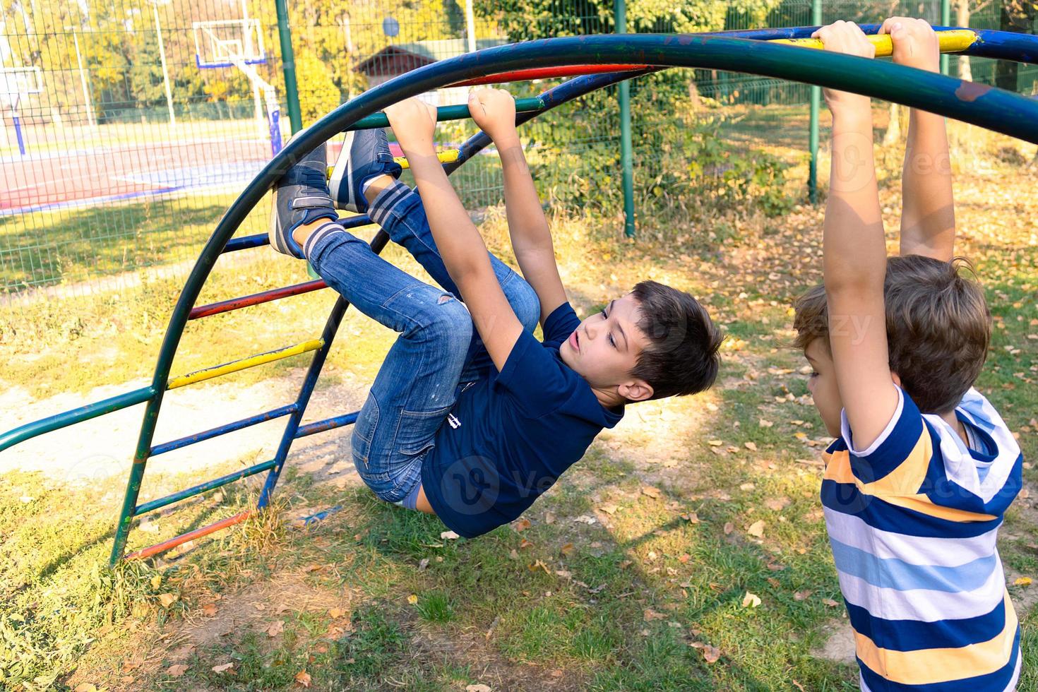 Two carefree boys enjoying while playing in the park. photo