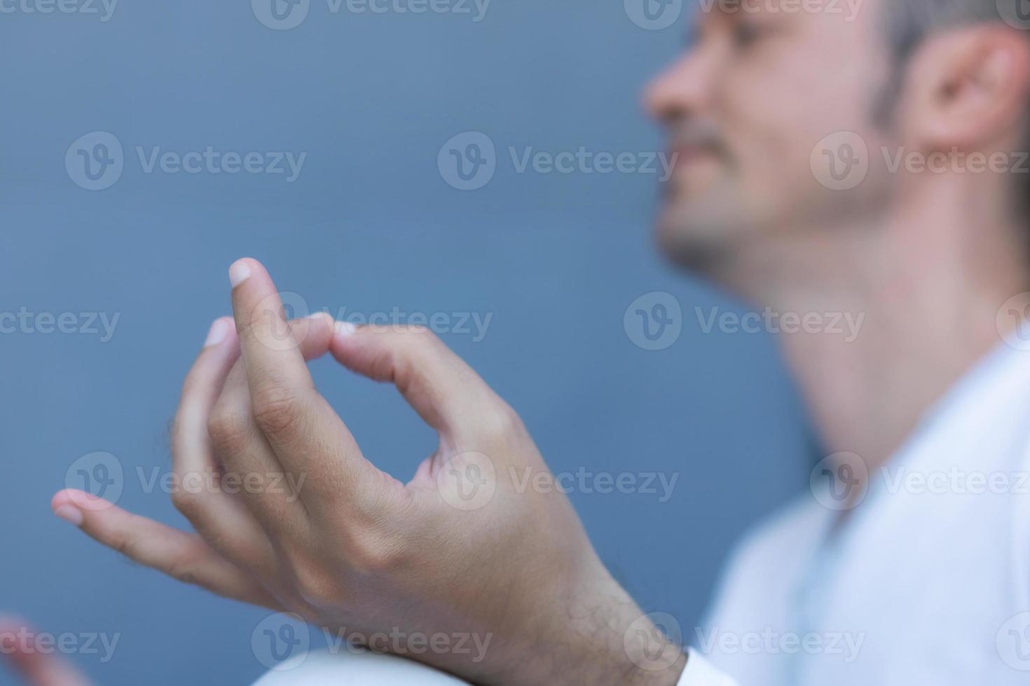 Close-up of man mediating during Yoga class. photo
