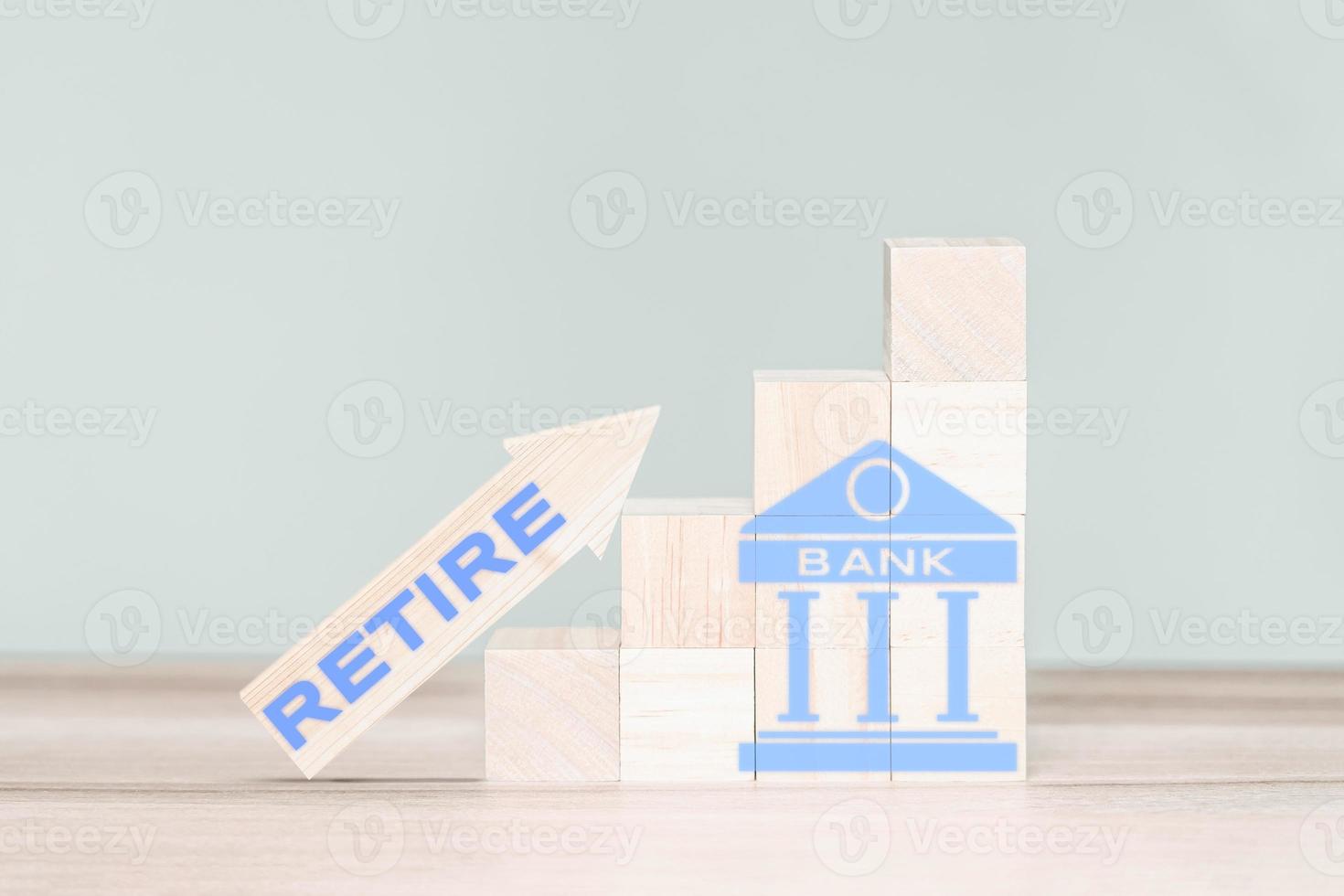 Wooden cube block with bank icon and wood arrow up with word retire. Retirement Planning Ideas. photo