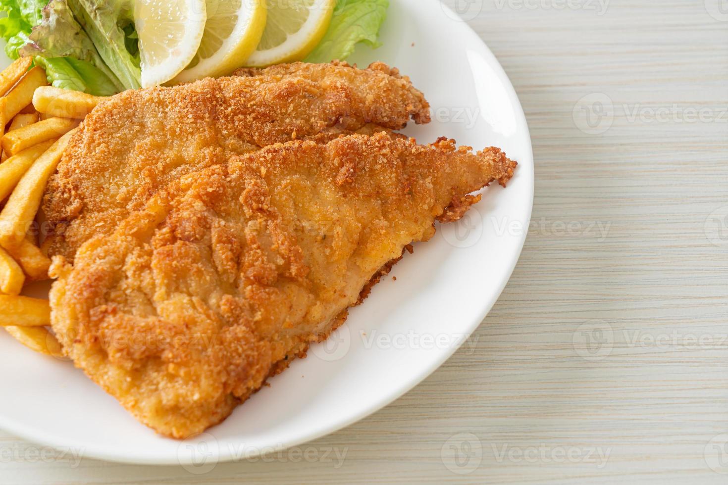 Homemade Breaded Weiner Schnitzel with Potato Chips photo