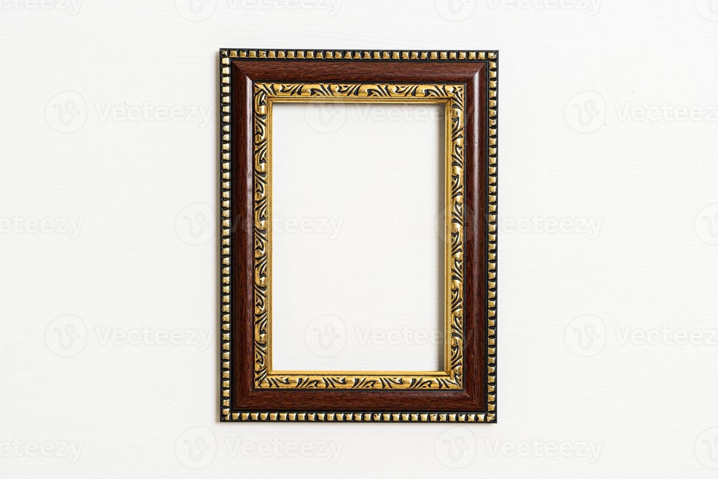 empty picture frame on white wall background photo