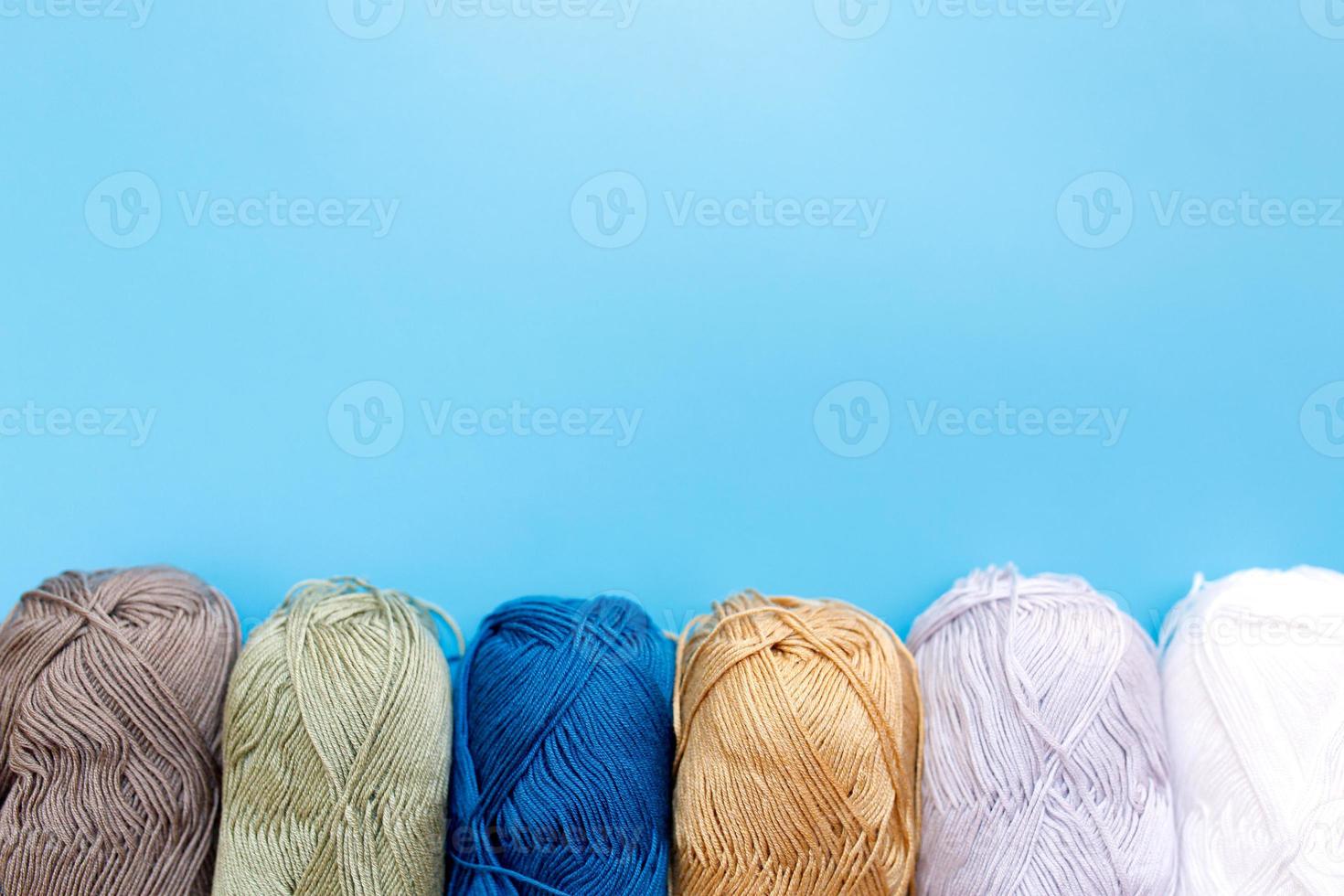 Skeins of wool yarn and knitting needles photo
