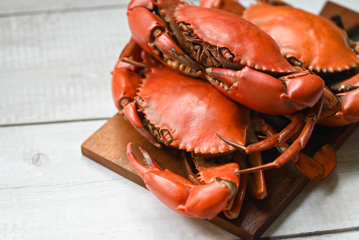 fresh crab on wooden cutting board, seafood crab cooking food boiled or steamed crab red in the seafood restaurant kitchen photo