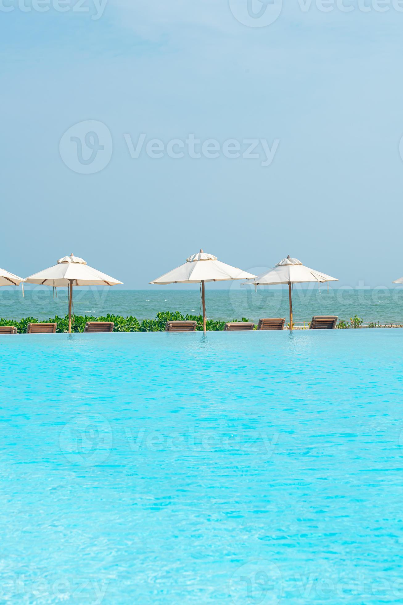 umbrella with bed pool around swimming pool with ocean sea background