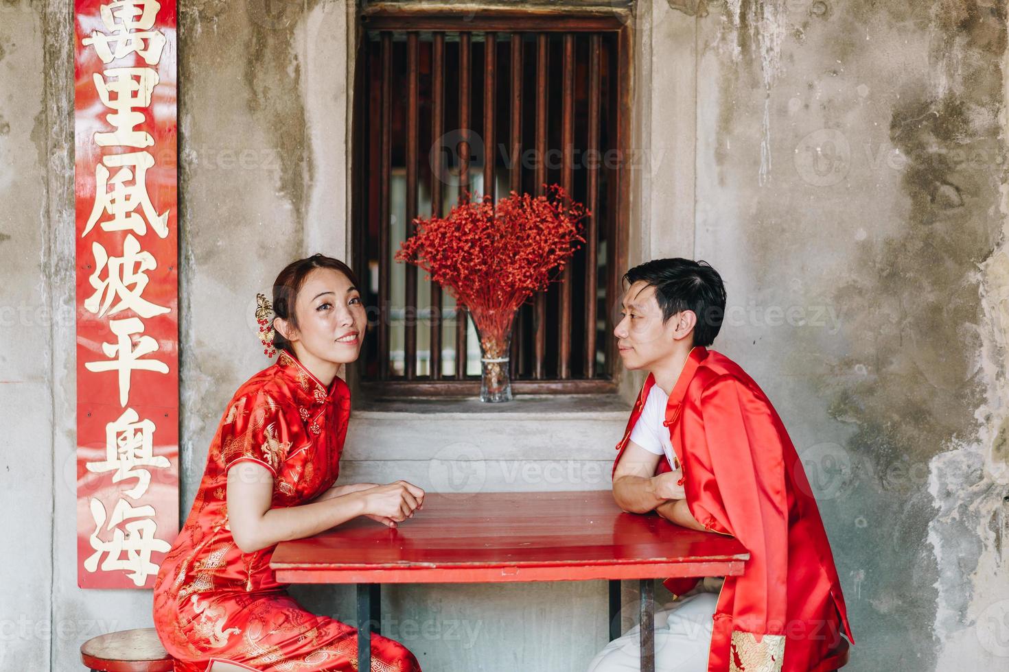 Happy young Asian couple in Chinese traditional dresses photo