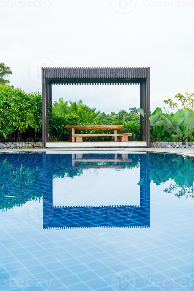 empty wood bench on poolside photo