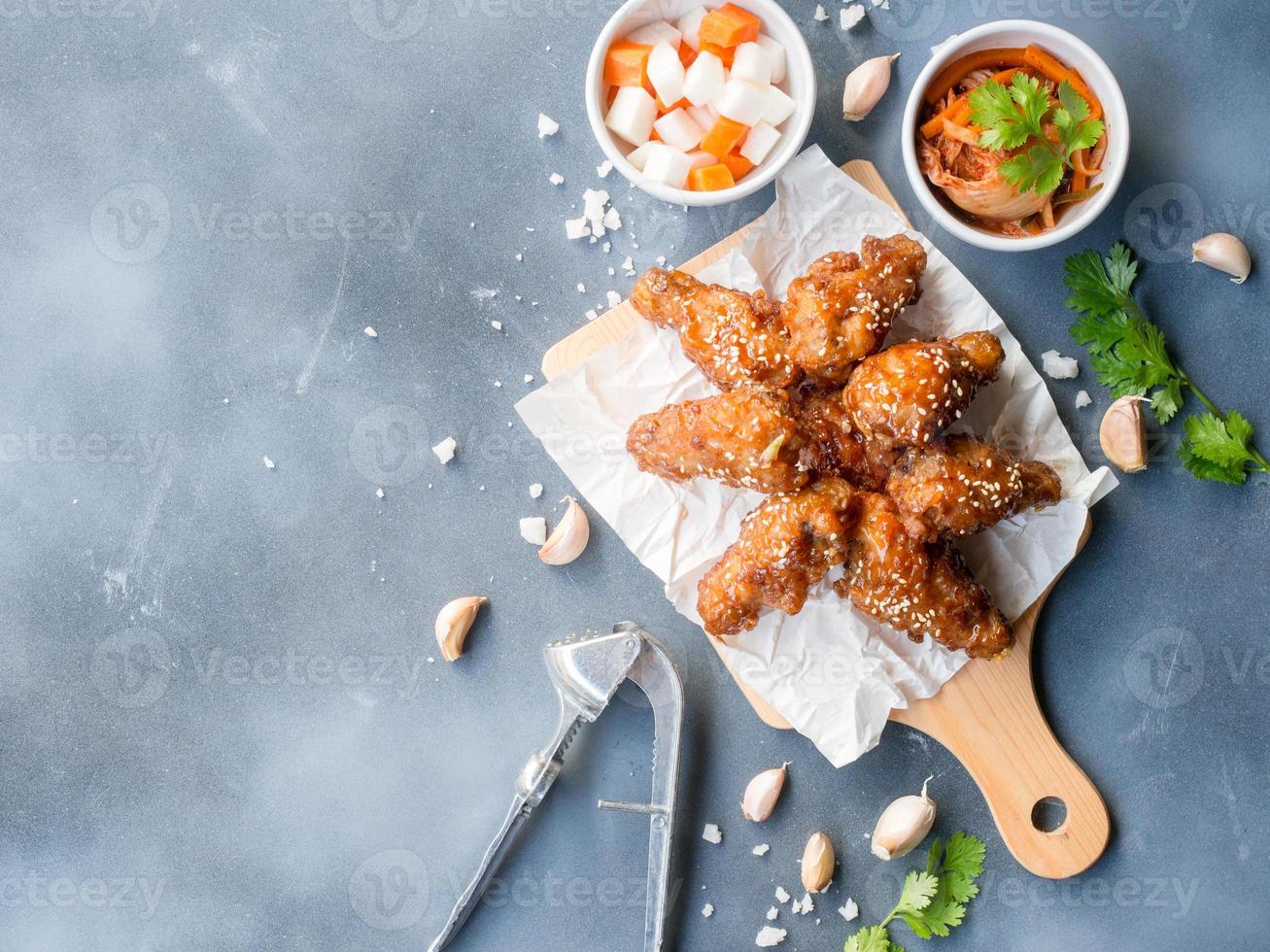 Deep fried chicken wing with garlic sauce in Korean style, top view with copy space. photo