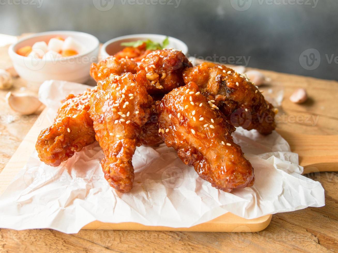 Deep fried chicken wing with garlic sauce in Korean style. photo
