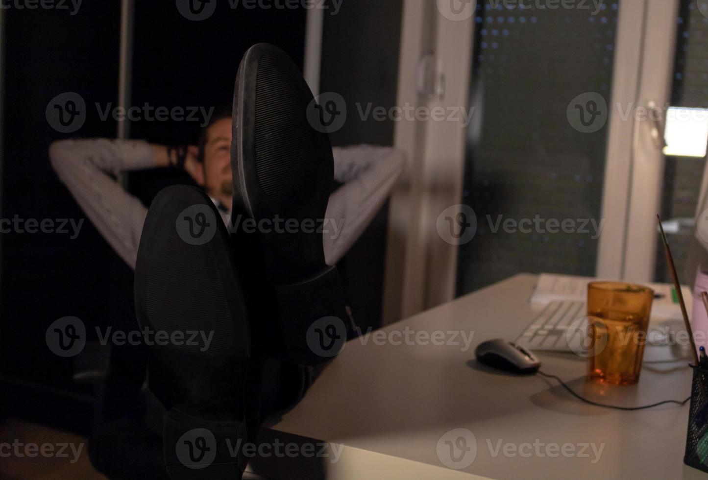 Close-up of businessman resting at night in the office. photo