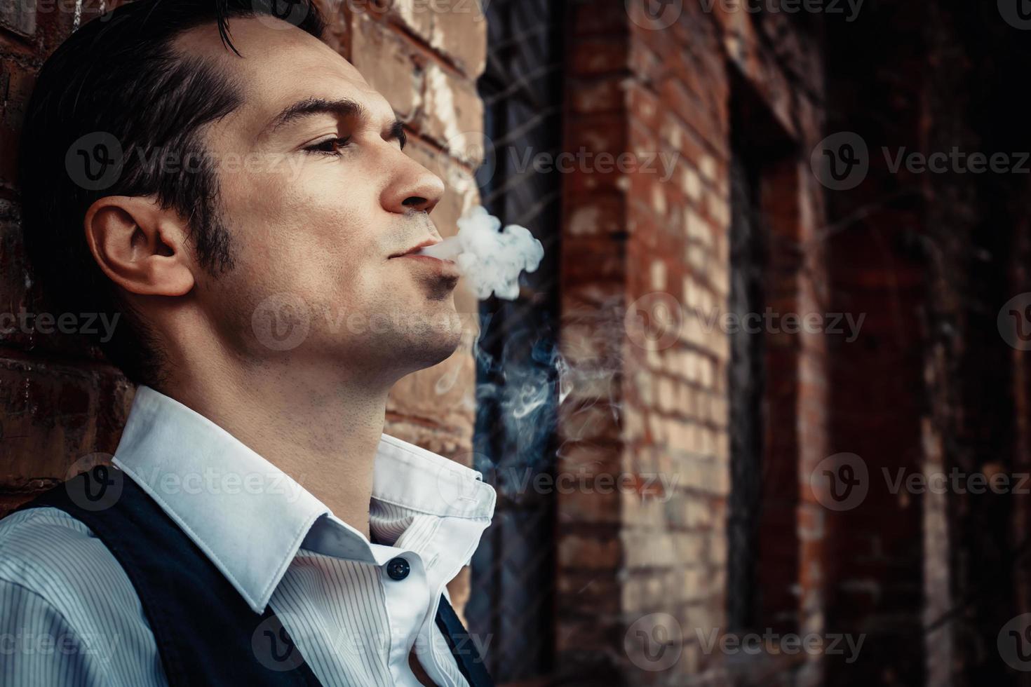 Close-up of man smoking outdoors. photo