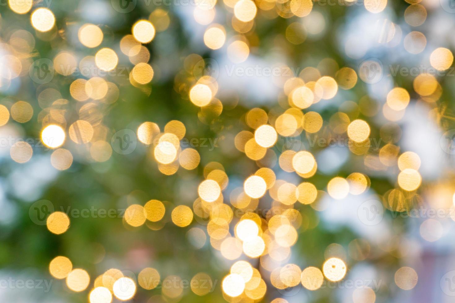 Bokeh abstract texture. Beautiful christmas background in golden colors. Defocused image photo
