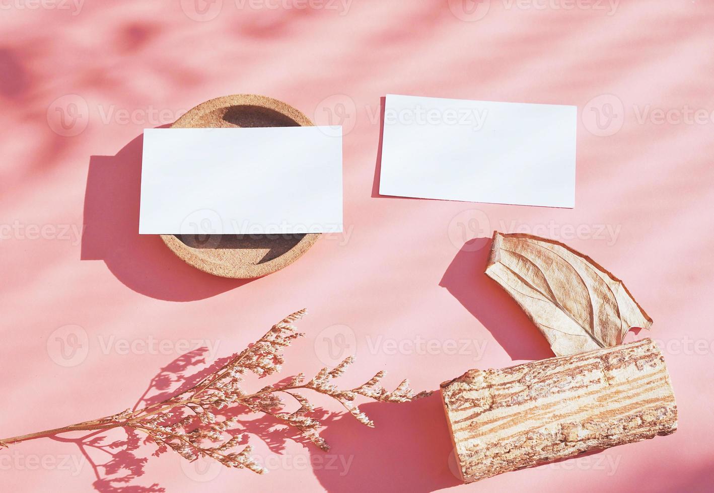 Flat lay of branding identity business name card on with dry flower and leaf, minimal light and shadow concept for design, autumn season style photo