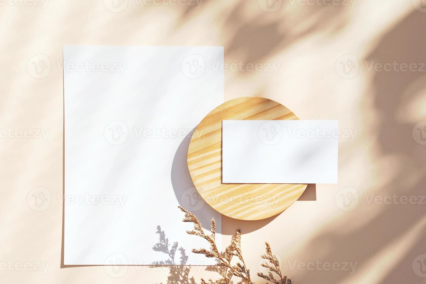 Flat lay of branding identity business name card on yellow background with flower, light and shadow shape leaves, minimal concept for design photo